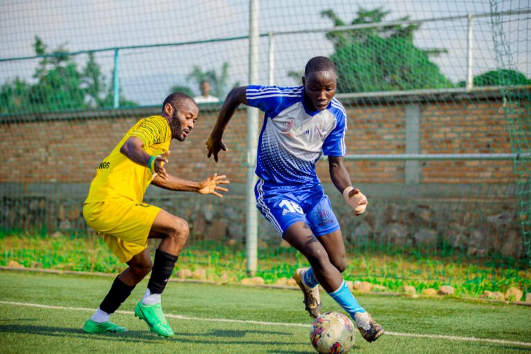 Two male soccer players engage in an intense match on an outdoor field.