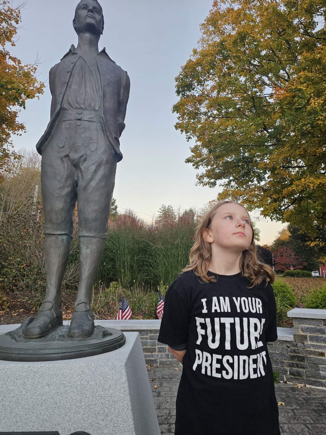 Adeline looking up at the bronze statue of Nathan Hale