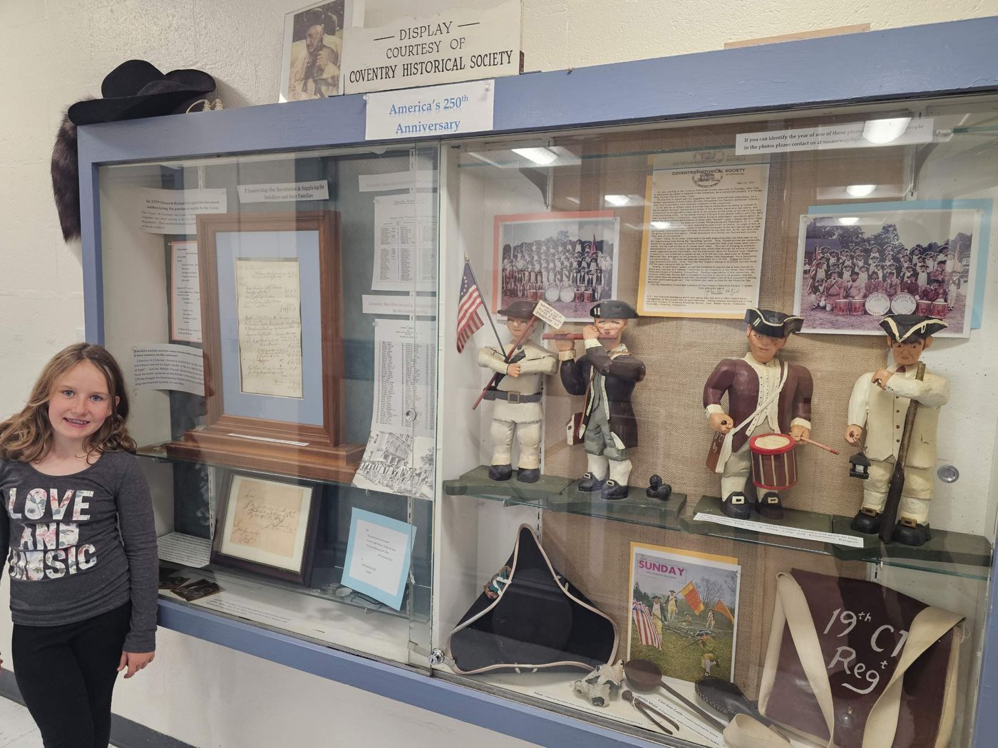 Adeline beside the Coventry Historical Society display for America's 250th anniversary