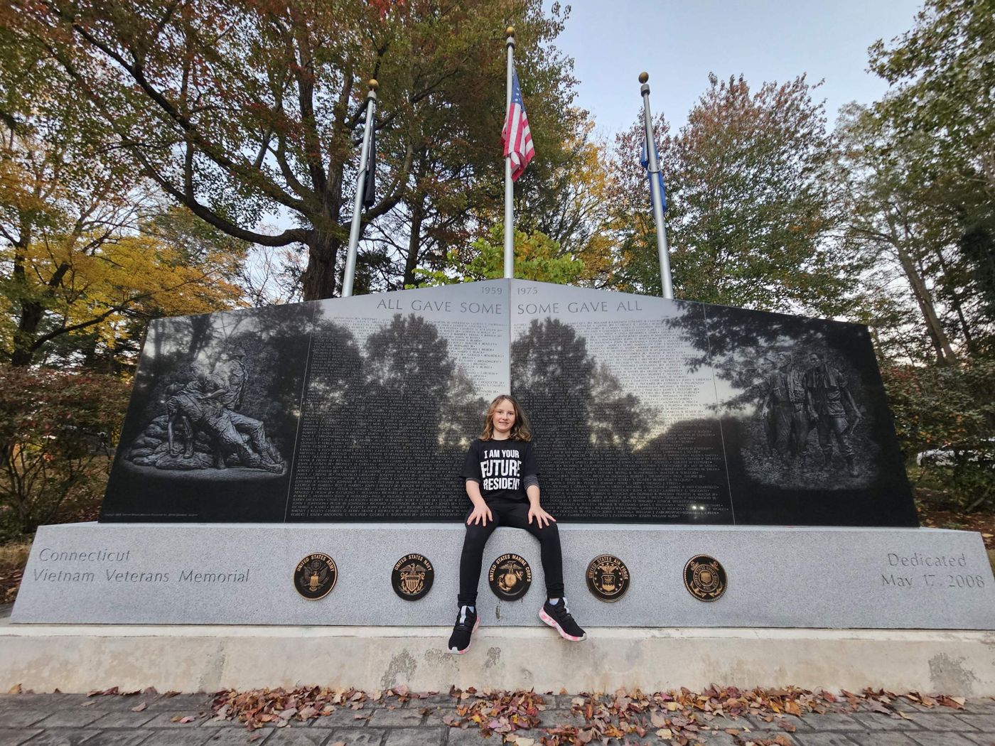 Adeline sitting at the Connecticut Vietnam Veterans Memorial